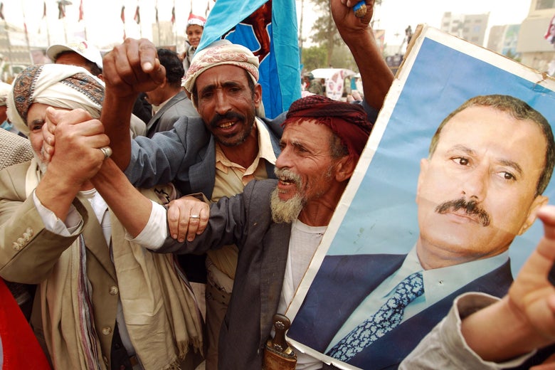 Yemeni protesters hold a portrait of Yemen's former president Ali Abdullah Saleh during a demonstration against airstrikes carried out by the Saudi-led Arab coalition against Huthi militia in the capital Sanaa on April 3, 2015. AFP PHOTO / MOHAMMED HUWAIS
(Photo credit should read MOHAMMED HUWAIS/AFP/Getty Images)